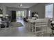 Bright living room with tile floors, comfy seating, and sliding glass doors leading to a patio at 624 Silk Oak Dr, Venice, FL 34293