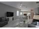 Open concept living area with gray sofas and a view of the kitchen at 624 Silk Oak Dr, Venice, FL 34293
