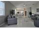 Spacious living room with gray sofas and views to kitchen and dining areas at 624 Silk Oak Dr, Venice, FL 34293
