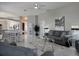 Open concept living area with gray sofas and a view into the kitchen at 624 Silk Oak Dr, Venice, FL 34293