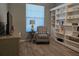 Cozy office with built-in shelving and comfy chair at 624 Silk Oak Dr, Venice, FL 34293