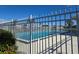 Community pool with fence and surrounding landscape at 624 Silk Oak Dr, Venice, FL 34293