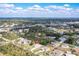Sprawling aerial view of a residential neighborhood with lush greenery and nearby highway access at 6502 Whelan St, Englewood, FL 34224