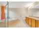 Well-lit bathroom featuring tiled flooring, double sinks, and a shower and tub combination at 6502 Whelan St, Englewood, FL 34224