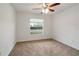 Clean bedroom with carpet, ceiling fan, and nature views at 6502 Whelan St, Englewood, FL 34224