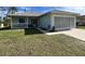 One-story house with a covered porch and attached garage at 6502 Whelan St, Englewood, FL 34224