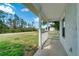 Charming front porch with white railings, offering a view of the neighborhood and lush surroundings at 6502 Whelan St, Englewood, FL 34224