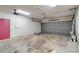 Spacious garage with concrete floors, garage door, and utility area with good lighting at 6502 Whelan St, Englewood, FL 34224