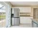 Kitchen featuring stainless steel appliances, white cabinetry, and a convenient side-by-side refrigerator at 6502 Whelan St, Englewood, FL 34224