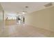 Expansive living space with tiled flooring, seamlessly connecting to the kitchen and dining areas at 6502 Whelan St, Englewood, FL 34224