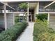 Condo building exterior showcasing a walkway, landscaping, and parking at 654 Bird Bay E Dr # 106, Venice, FL 34285