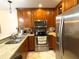 Well-equipped kitchen with stainless steel appliances and wood cabinets at 654 Bird Bay E Dr # 106, Venice, FL 34285