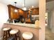 Modern kitchen with granite countertops, breakfast bar, and ample cabinetry at 654 Bird Bay E Dr # 106, Venice, FL 34285