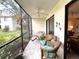 Screened lanai with patio furniture, offering a relaxing outdoor space at 654 Bird Bay E Dr # 106, Venice, FL 34285