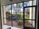 View from the lanai showcasing lush landscaping and AC units at 654 Bird Bay E Dr # 106, Venice, FL 34285