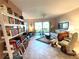 Bright living room with comfy seating, a bookcase, and access to a patio at 654 Bird Bay E Dr # 106, Venice, FL 34285