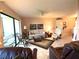 Spacious living room featuring a sofa, armchairs, and large windows at 654 Bird Bay E Dr # 106, Venice, FL 34285