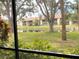 Peaceful view of a pond and lush greenery from a condo at 654 Bird Bay E Dr # 106, Venice, FL 34285