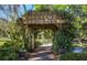 Entrance to Monty Andrews Arboretum with wooden pergola and lush greenery at 655 Crossfield Cir # 7, Venice, FL 34293