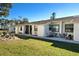 Exterior view of the condo building, showcasing landscaping at 6796 Gasparilla Pines Blvd # 70, Englewood, FL 34224