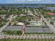 Expansive aerial view of a community, featuring tennis courts, lush greenery, and residential homes, showcasing recreational amenities at 705 Armada N Rd, Venice, FL 34285