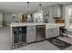 Kitchen with light gray cabinets, stainless steel appliances, farmhouse sink and beverage refrigerator at 705 Armada N Rd, Venice, FL 34285