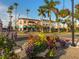 Picturesque street view of the neighborhood, displaying colorful flower pots, hanging baskets, and commercial buildings at 705 Armada N Rd, Venice, FL 34285