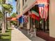 Building in the neighborhood featuring several country flags under an awning and benches for seating at 705 Armada N Rd, Venice, FL 34285