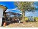 Large backyard with a screened-in pool and patio area at 7148 Totem Ave, North Port, FL 34291