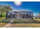 Large backyard with screened-in pool and patio visible at 7148 Totem Ave, North Port, FL 34291