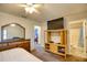 Bedroom with a large TV, dresser, and view into another bedroom at 7148 Totem Ave, North Port, FL 34291
