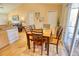 Bright dining area with wood table and chairs, adjacent to kitchen at 7148 Totem Ave, North Port, FL 34291