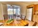 Dining area with wood table and chairs, view of screened patio and pool at 7148 Totem Ave, North Port, FL 34291