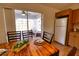 Dining area with wood table and chairs, view of screened patio and pool at 7148 Totem Ave, North Port, FL 34291