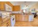 Modern kitchen with light wood cabinets, granite countertops, and stainless steel appliances at 7148 Totem Ave, North Port, FL 34291