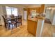 Kitchen with light wood cabinets and a dining area at 7148 Totem Ave, North Port, FL 34291