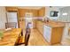 Kitchen with light wood cabinets, granite countertops, and white appliances at 7148 Totem Ave, North Port, FL 34291
