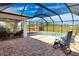 Covered patio with seating area adjacent to refreshing pool at 7148 Totem Ave, North Port, FL 34291