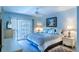 Cozy bedroom with access to balcony, featuring blue bedding at 832 Bird Bay Way # 113, Venice, FL 34285