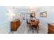 Charming dining room featuring a wooden table and chandelier at 832 Bird Bay Way # 113, Venice, FL 34285