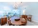 Open concept dining room with seating and living room view at 832 Bird Bay Way # 113, Venice, FL 34285
