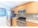 Modern kitchen with stainless steel appliances and granite counters at 832 Bird Bay Way # 113, Venice, FL 34285
