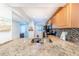 Granite countertop kitchen with stainless steel appliances at 832 Bird Bay Way # 113, Venice, FL 34285