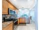 Updated kitchen with stainless steel appliances and wood cabinets at 832 Bird Bay Way # 113, Venice, FL 34285