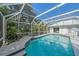 Large, screened pool with tiled steps at 855 Morgan Towne Way, Venice, FL 34292