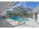 Screened-in pool with spa and lush landscaping at 855 Morgan Towne Way, Venice, FL 34292