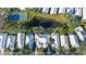 Aerial view showing home's location in community with tennis court and lake at 1009 Harbor Town Dr, Venice, FL 34292