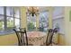 Charming breakfast nook with table and chairs in a bright, sunny room at 1009 Harbor Town Dr, Venice, FL 34292