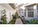 Inviting walkway to front door, flanked by lush greenery and wrought-iron accents at 1009 Harbor Town Dr, Venice, FL 34292