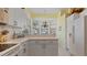 L-shaped kitchen with white cabinets and a window overlooking the outdoors at 1009 Harbor Town Dr, Venice, FL 34292